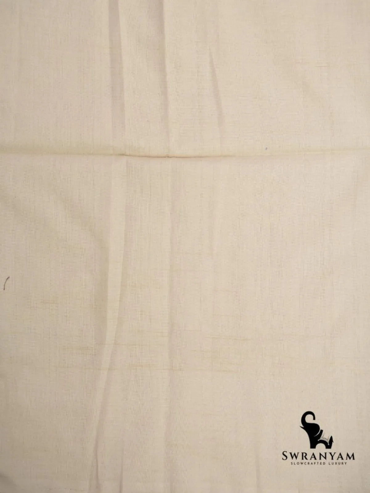Close up of plain ivory handwoven cotton fabric of grey and indigo ikat saree