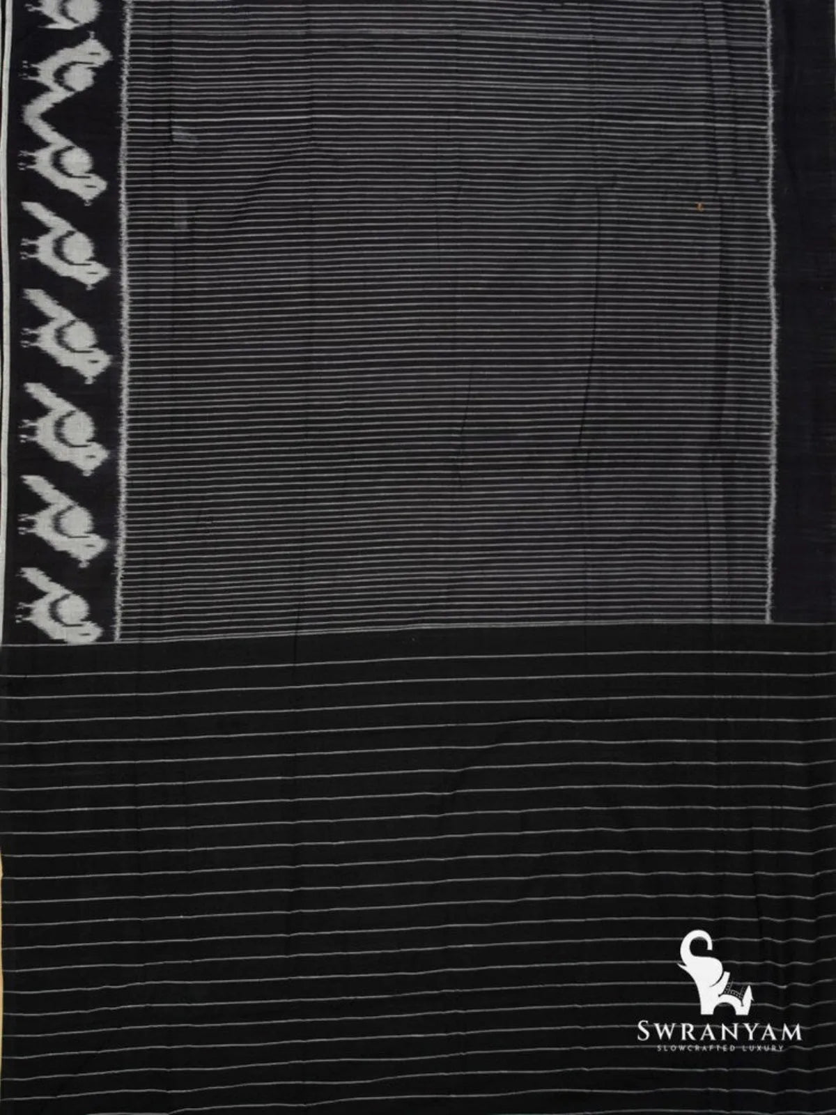Flat lay of black Pochampally ikat cotton saree with striped body, white ikat motif border and striped pallu