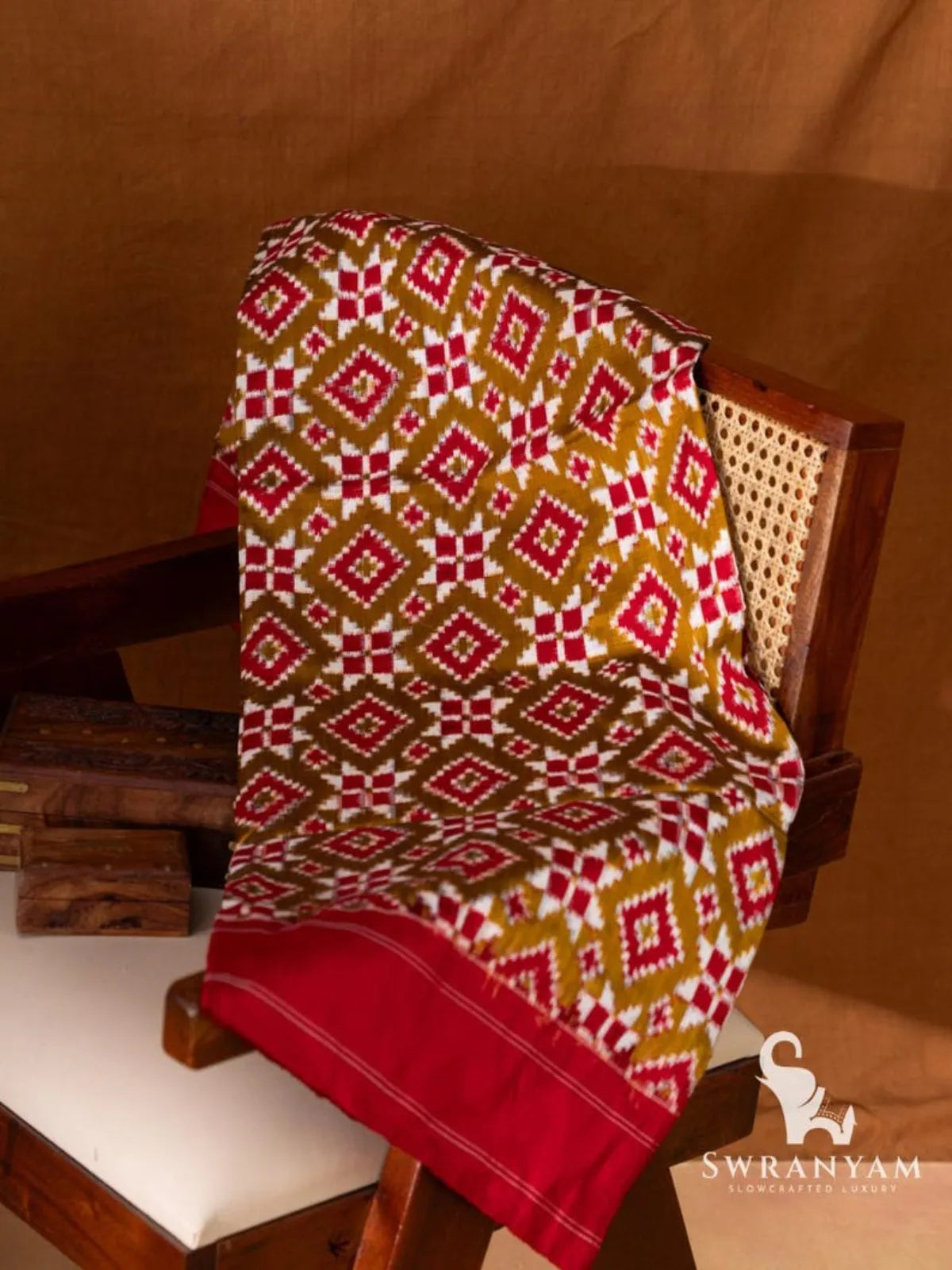 Olive green Pochampally Telia Rumal double ikat silk saree with red and white diamond motifs and red border folded