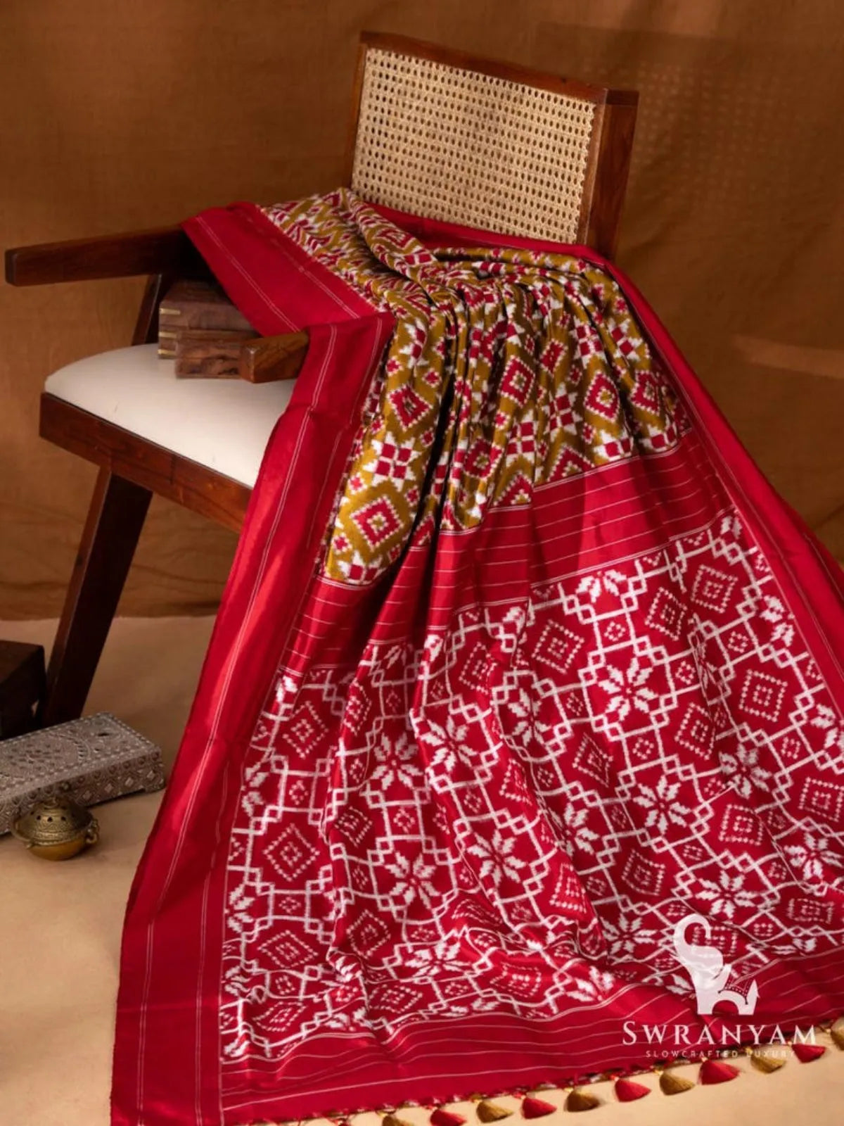 Olive green Telia Rumal double ikat silk saree with red pallu of white geometric ikat motifs and olive and red tassels