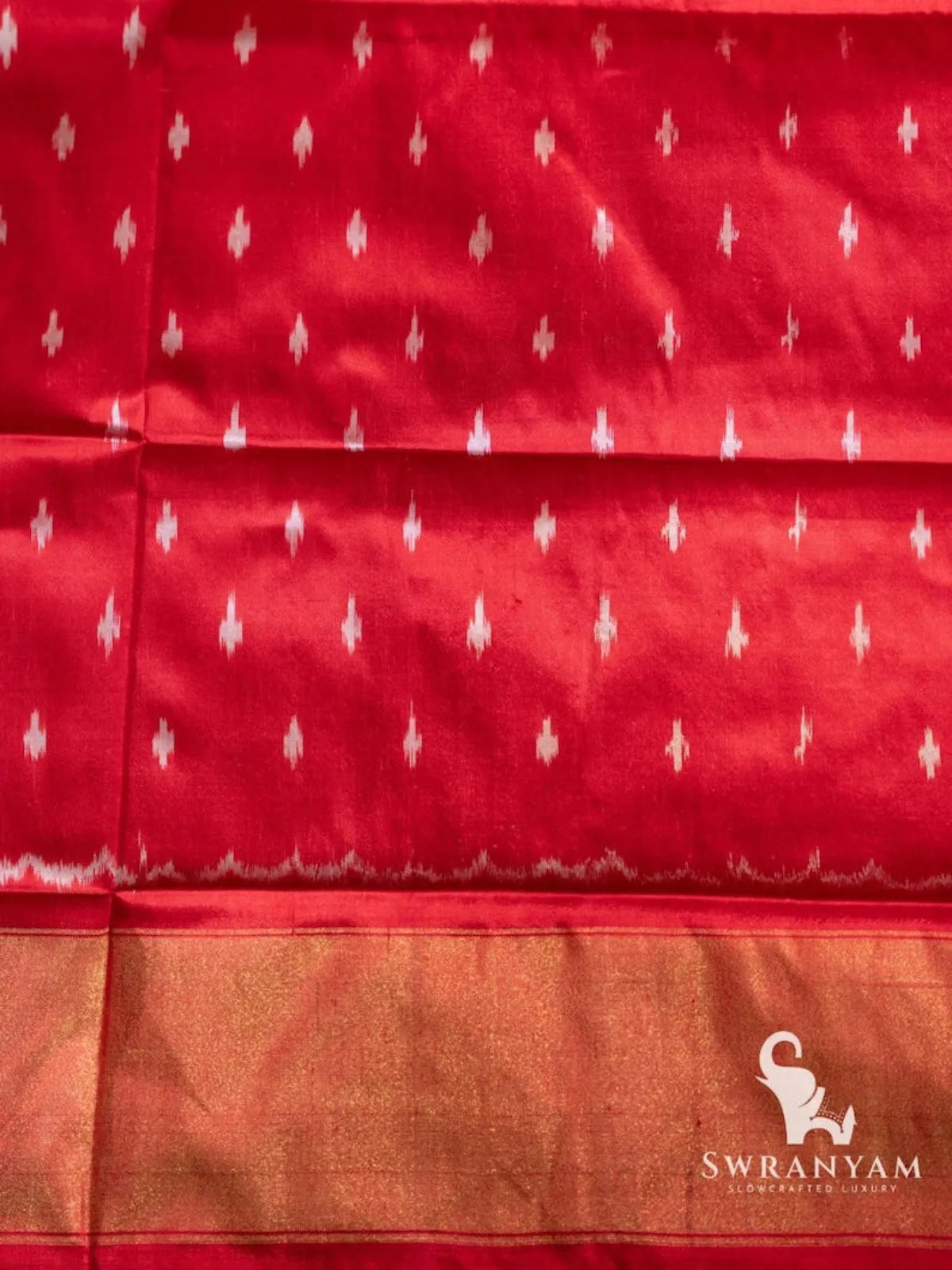 Red silk fabric with small white ikat dot motifs and gold zari band, matching piece for the red Pochampally ikat saree