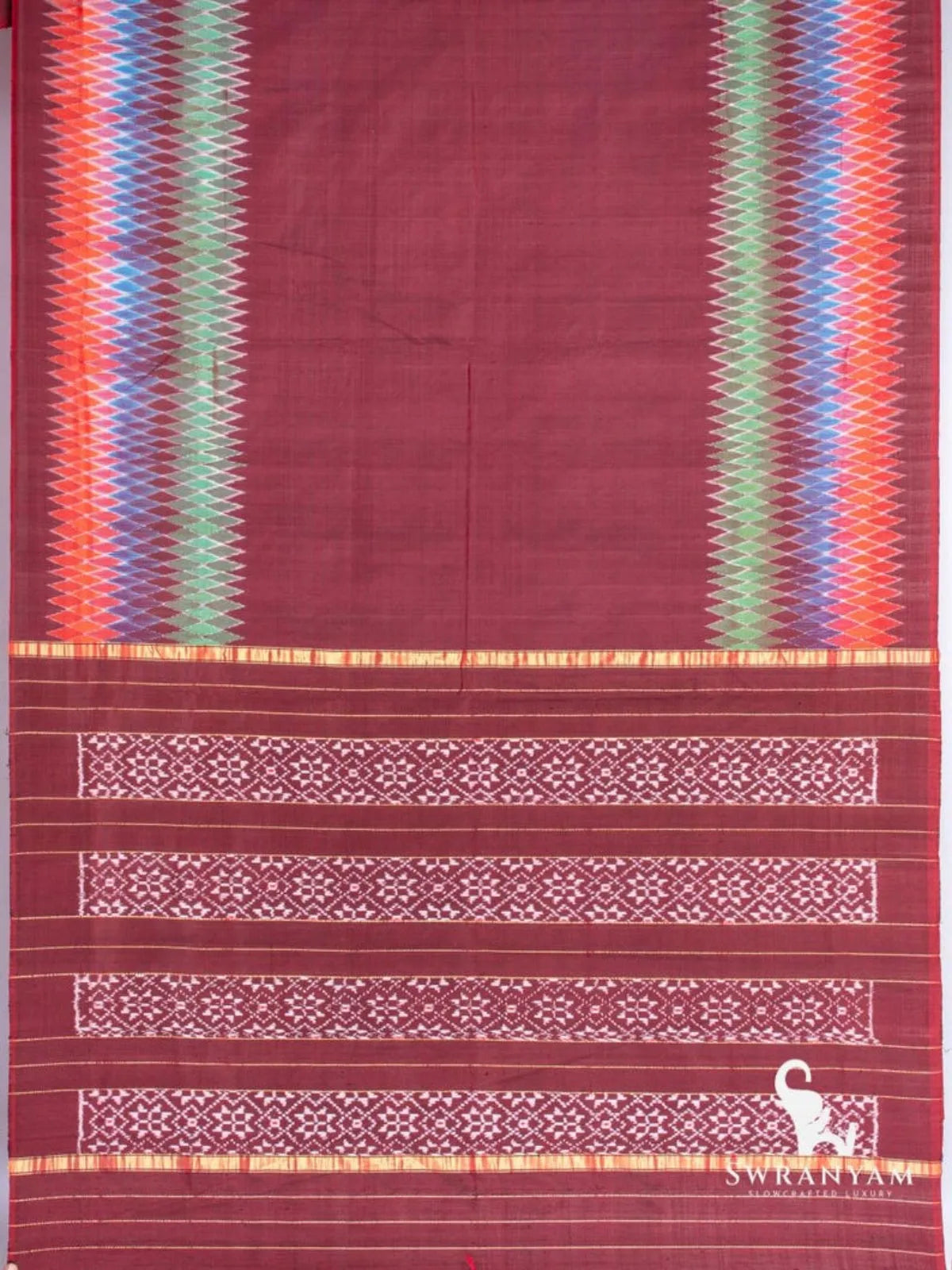 Maroon Pochampally ikat silk saree spread flat showing multicolour diamond ikat borders and pallu with white ikat blocks