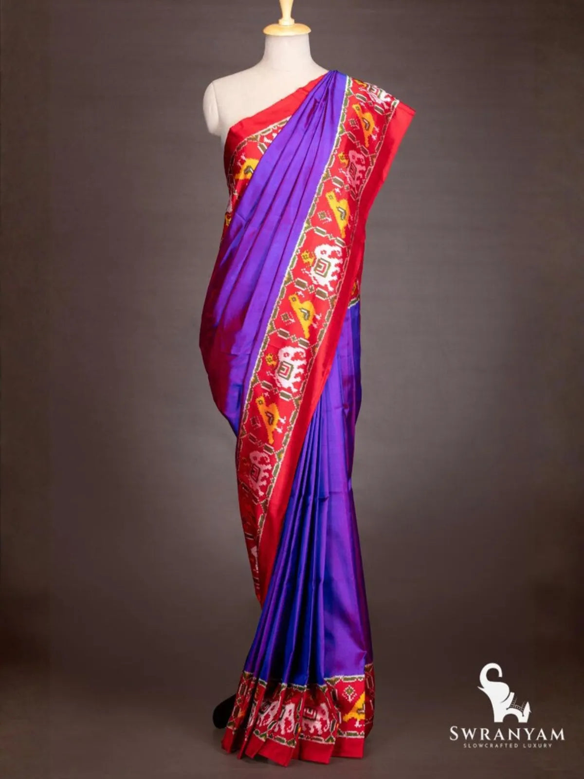 Royal purple Pochampally ikat silk saree with red ikat border of elephant and bird motifs on mannequin, front view