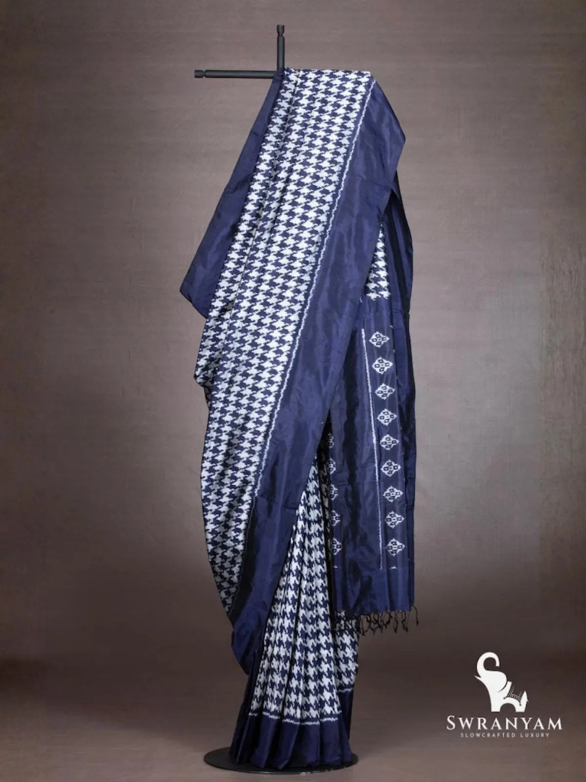 Indigo blue Pochampally ikat silk saree with white houndstooth ikat body and diamond motif pallu draped on stand