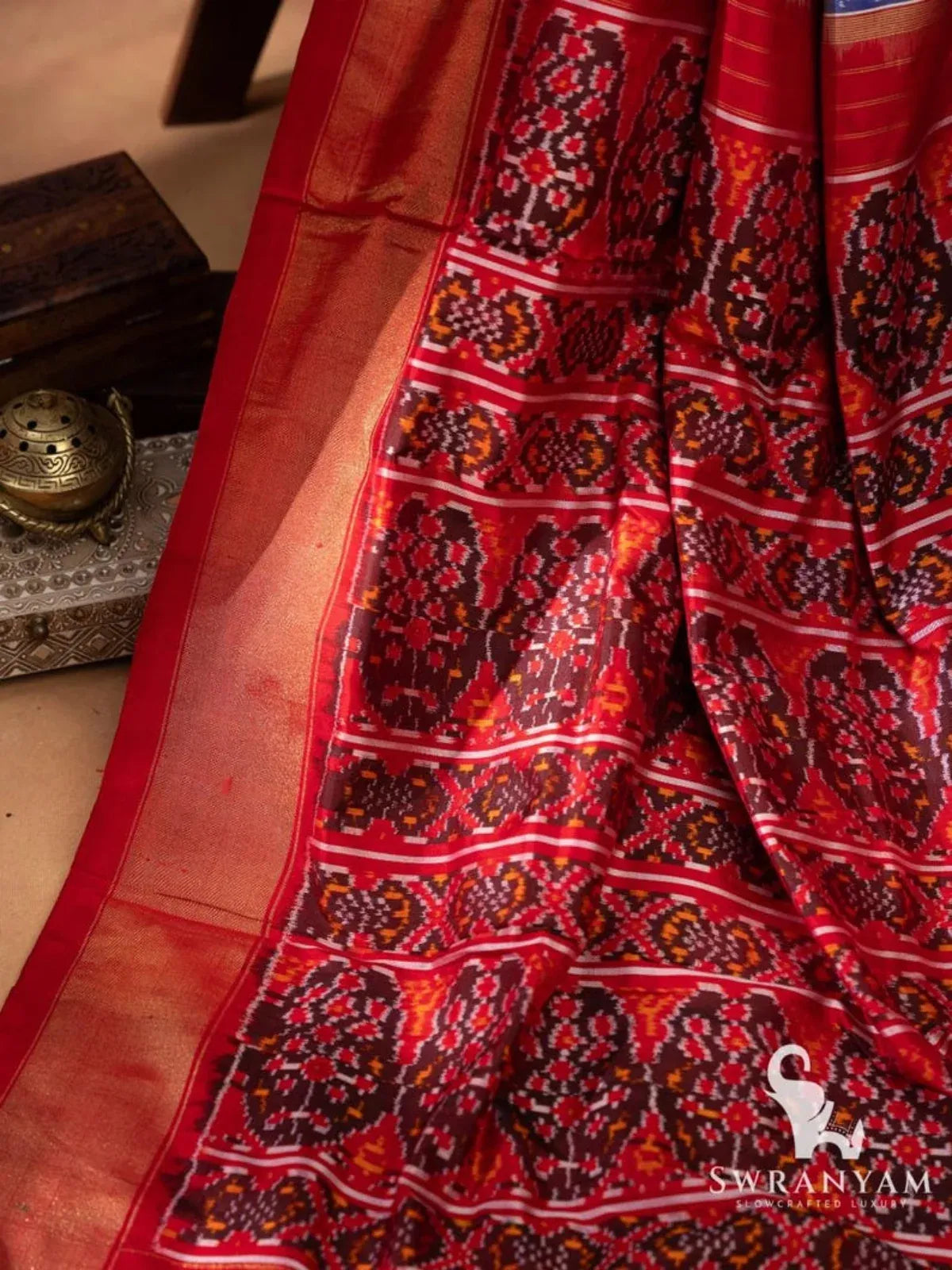 Red ikat pallu with intricate woven motifs and red zari temple border of Pochampally silk saree