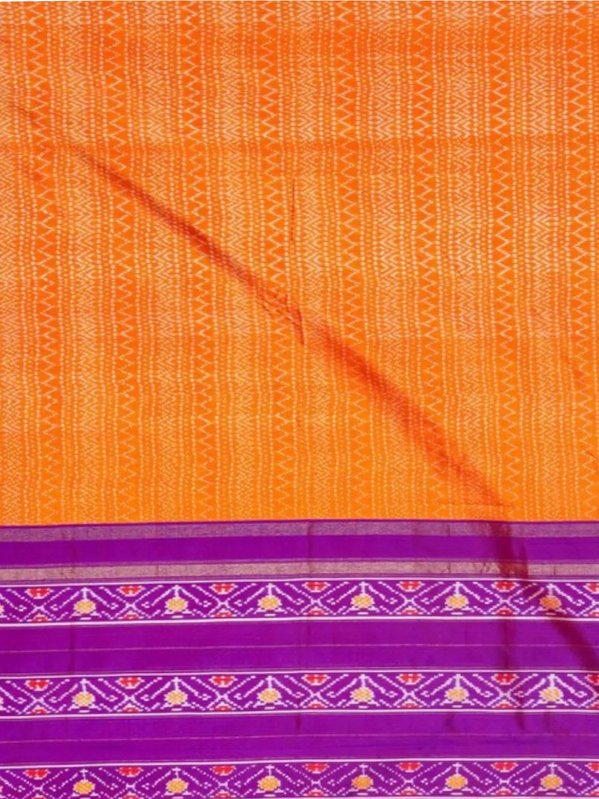 Orange zigzag ikat silk body with purple border bands of woven ikat motifs on Pochampally twill saree