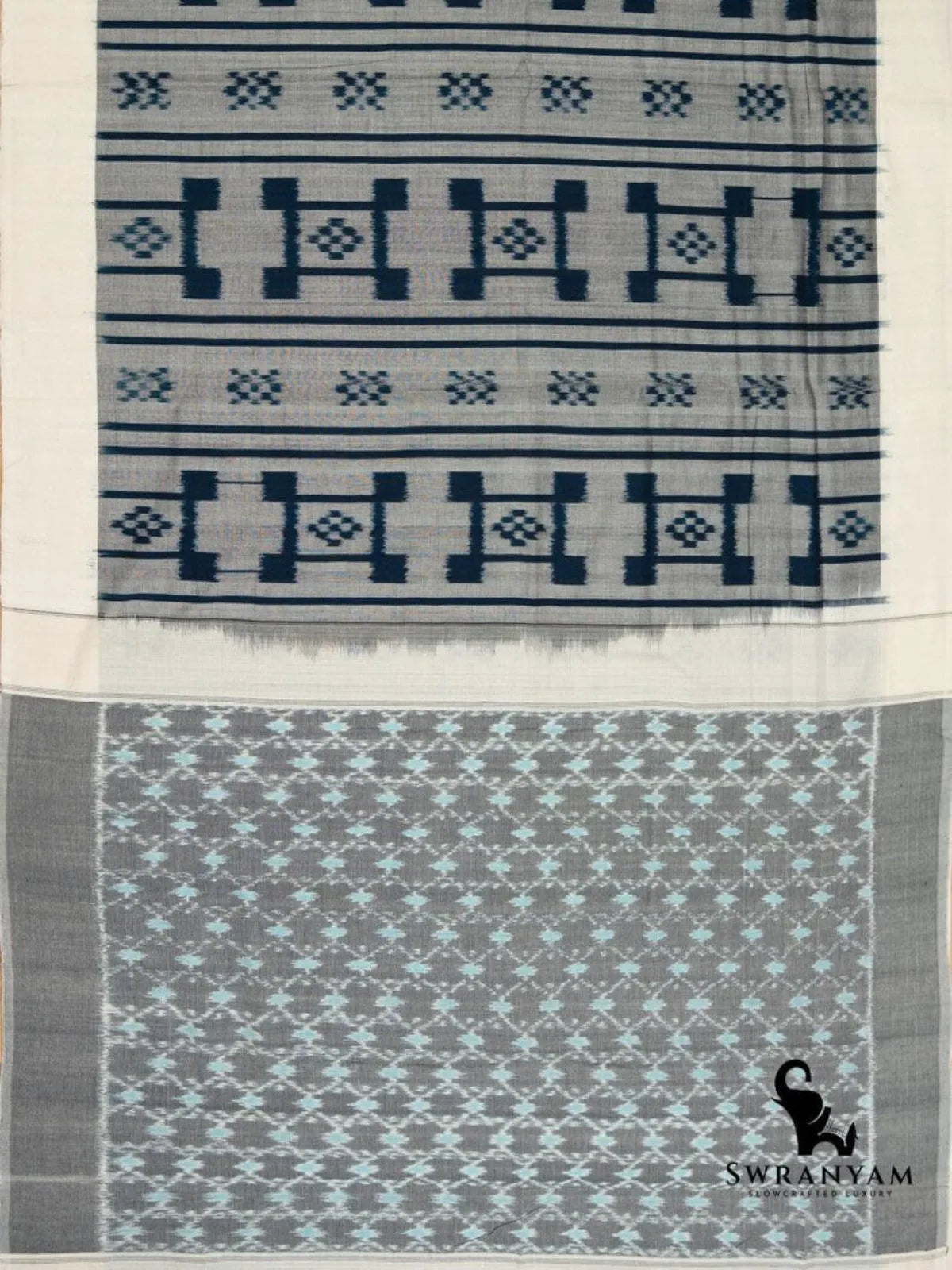 Flat lay of grey Pochampally ikat cotton saree with indigo geometric motifs, ivory border and light blue ikat jaal pallu