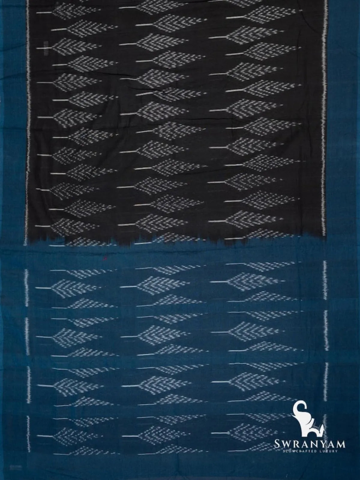 Flat lay of black Pochampally ikat cotton saree with leaf motif body and teal blue ikat pallu