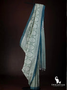Full length view of handwoven sage green Pochampally ikat silk cotton saree with contrast teal border