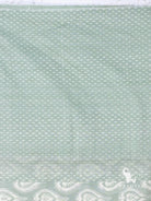 Close up of white dotted weft ikat weave on sage green silk cotton saree body