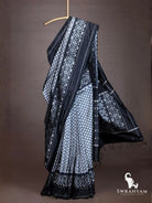 Full drape of handloom black grey ikkat silk saree with flowing geometric ikat pallu and black tassels