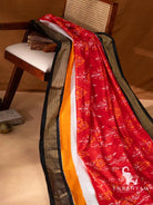 Full length drape of pure silk Pochampally ikat saree in red with yellow, white and black golden zari border