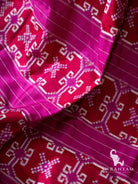 Close-up of red double ikat motif bands between magenta pinstriped sections on the pallu of a Telia Rumal silk saree