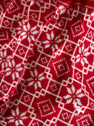 Close-up of white double ikat lattice, diamond and star motifs on red silk pallu of Telia Rumal saree