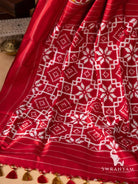 Red pallu with white double ikat lattice and star motifs, thin white stripes and olive and red tassels