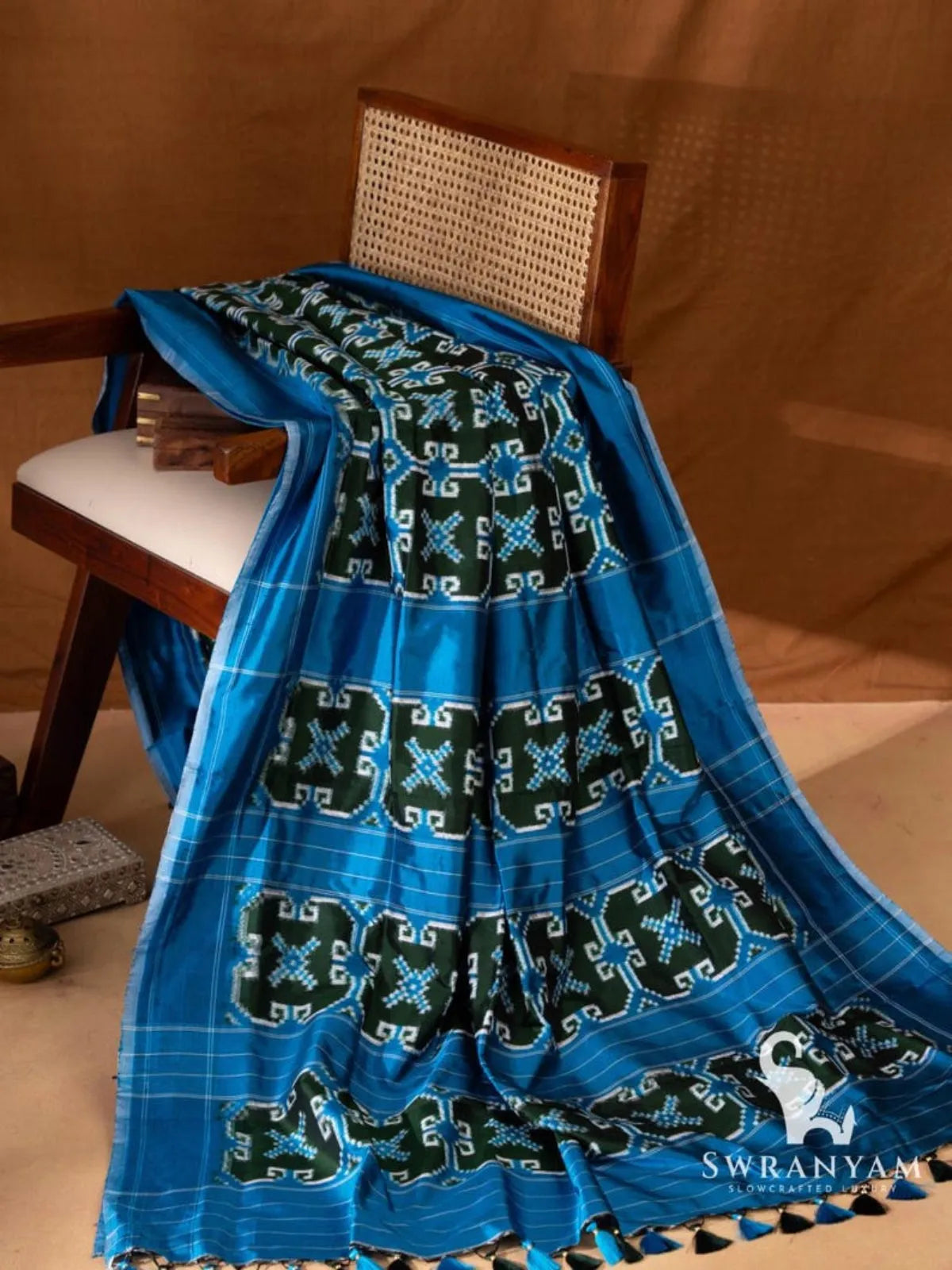 Blue Pochampally Telia Rumal double ikat silk saree with green ikat motif panels on the pallu and blue and black tassels