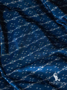 Close-up of deep blue Pochampally ikat silk with white vine and dot motifs in horizontal rows