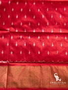 Red silk fabric with small white ikat dot motifs and gold zari band, matching piece for the red Pochampally ikat saree