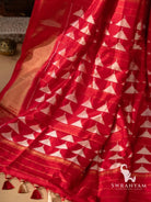 Close-up of red silk pallu with rows of white temple triangle ikat motifs and thin gold zari lines