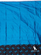 Plain bright blue silk section with black edge band of blue Z-shaped ikat motifs, part of the black Pochampally ikat saree