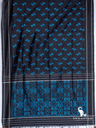 Black Pochampally ikat silk saree spread flat showing blue Z-shaped ikat motifs and pallu with blue geometric ikat panel