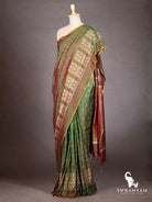 Side view of bottle green maroon Pochampally ikat silk saree with white and orange ikat border motifs