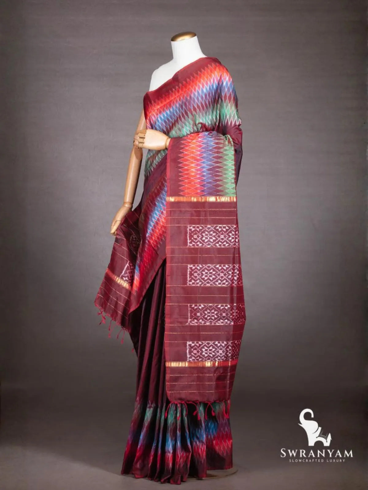 Maroon ikat silk saree with multicolour diamond ikat borders and maroon pallu with white ikat blocks and gold zari stripes