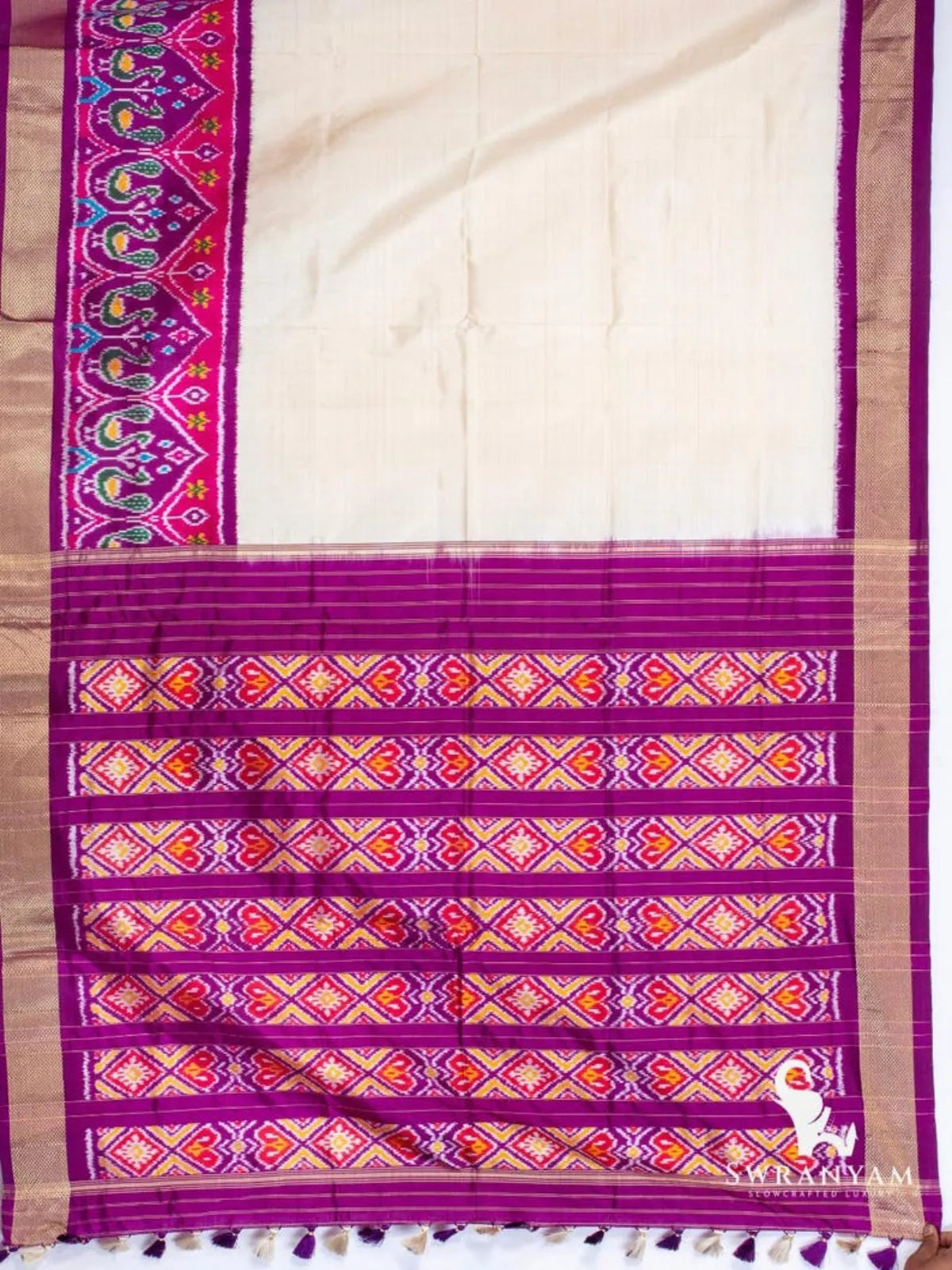 Ivory Pochampally ikat silk saree spread flat with peacock ikat border and purple pallu with diamond ikat panels