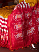 Close-up of crimson red pallu with white and orange horse ikat motifs, zari stripes and tassels on mustard yellow saree