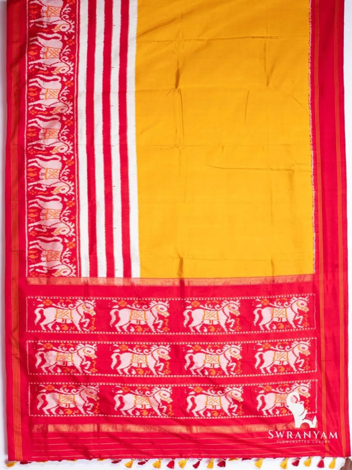 Mustard yellow Pochampally ikat silk saree spread flat with red and white ikat stripes and crimson pallu with horse motifs