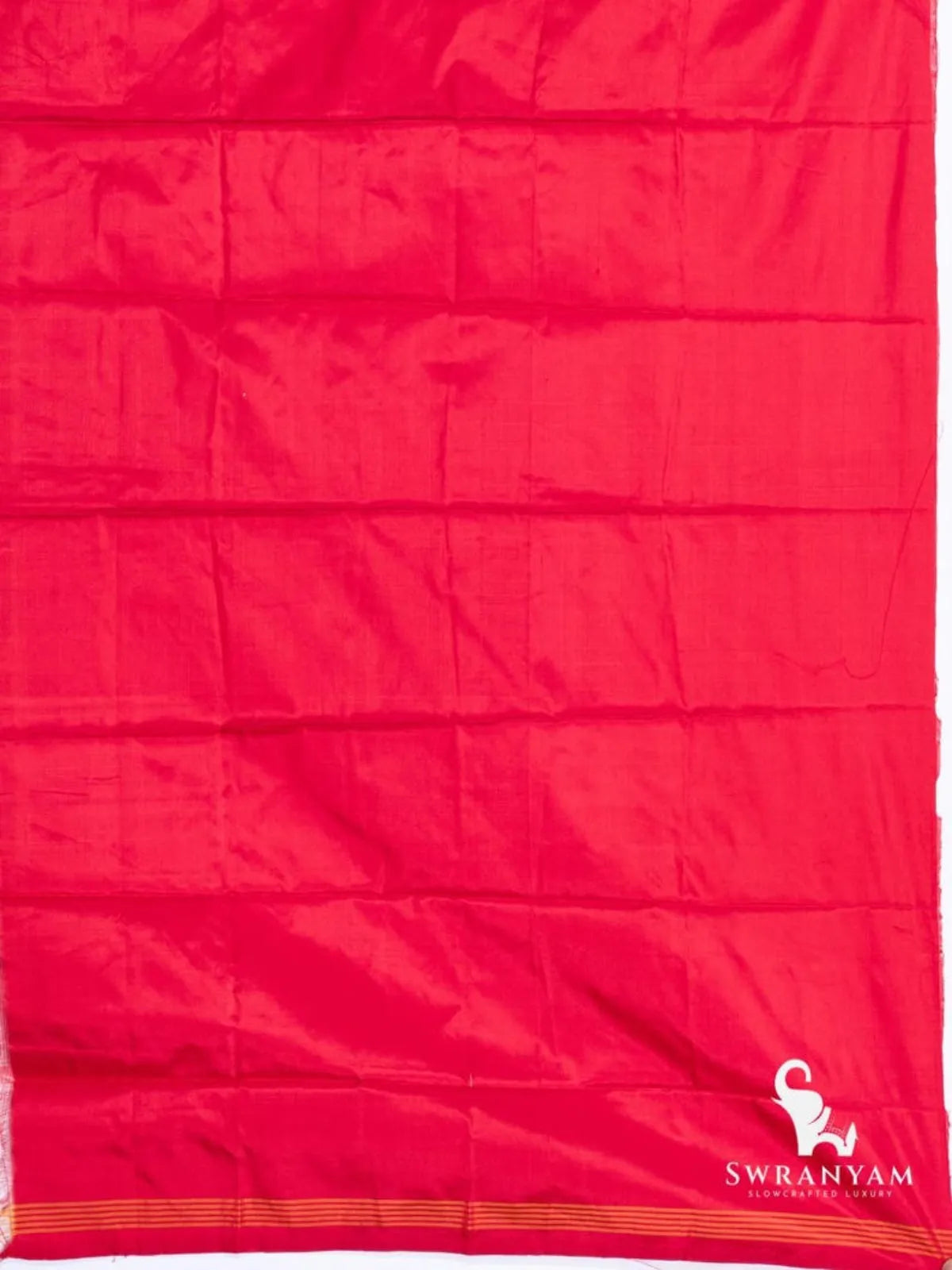 Plain crimson red silk fabric with orange striped edge, part of the mustard yellow Pochampally ikat saree