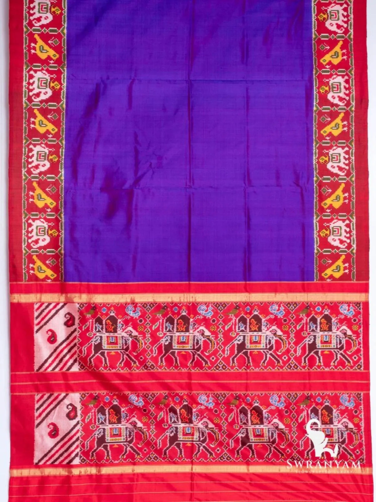 Royal purple Pochampally ikat silk saree spread flat with red elephant and bird border and elephant procession pallu