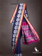 Navy blue ikat silk saree with white elephant motifs and flowing pink pallu with multicolour ikat panels and tassels