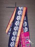 Close-up of white elephant ikat motifs on navy blue silk saree with gold zari and maroon border