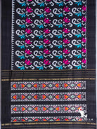 Black Pochampally ikat silk saree spread flat with white scroll and magenta tulip motifs and multicolour ikat pallu panels