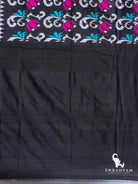 Plain black silk blouse piece at the end of the black Pochampally ikat silk saree with magenta tulip ikat motifs
