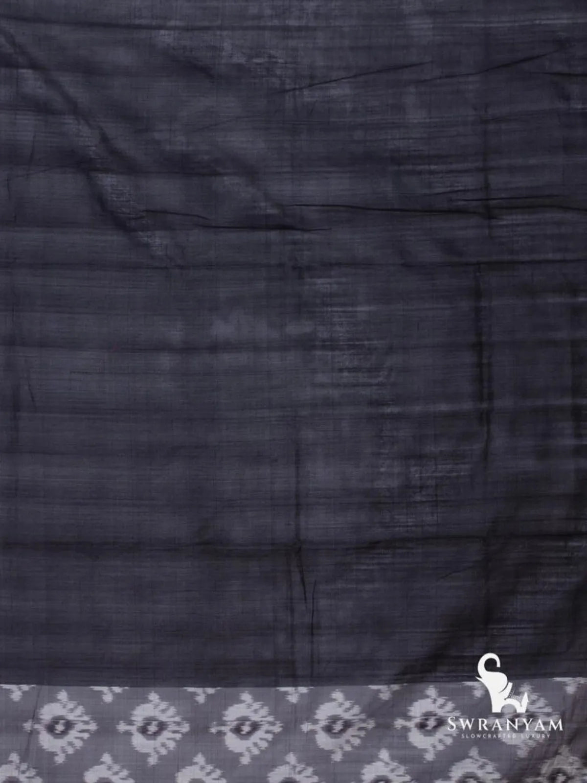 Plain black cotton silk fabric with white ikat motif edge on the charcoal grey Pochampally ikat saree