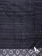 Plain black cotton silk fabric with white ikat motif edge on the charcoal grey Pochampally ikat saree