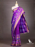 Royal purple ikat silk saree with antique gold zari border and pallu with floral ikat bands and purple and cream tassels