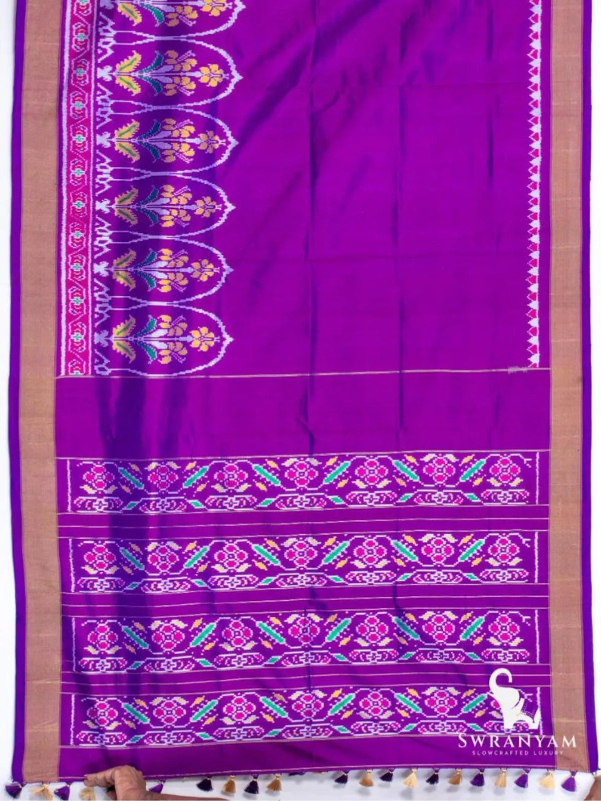 Royal purple Pochampally ikat silk saree spread flat showing floral ikat border, gold zari edges and pallu with ikat bands