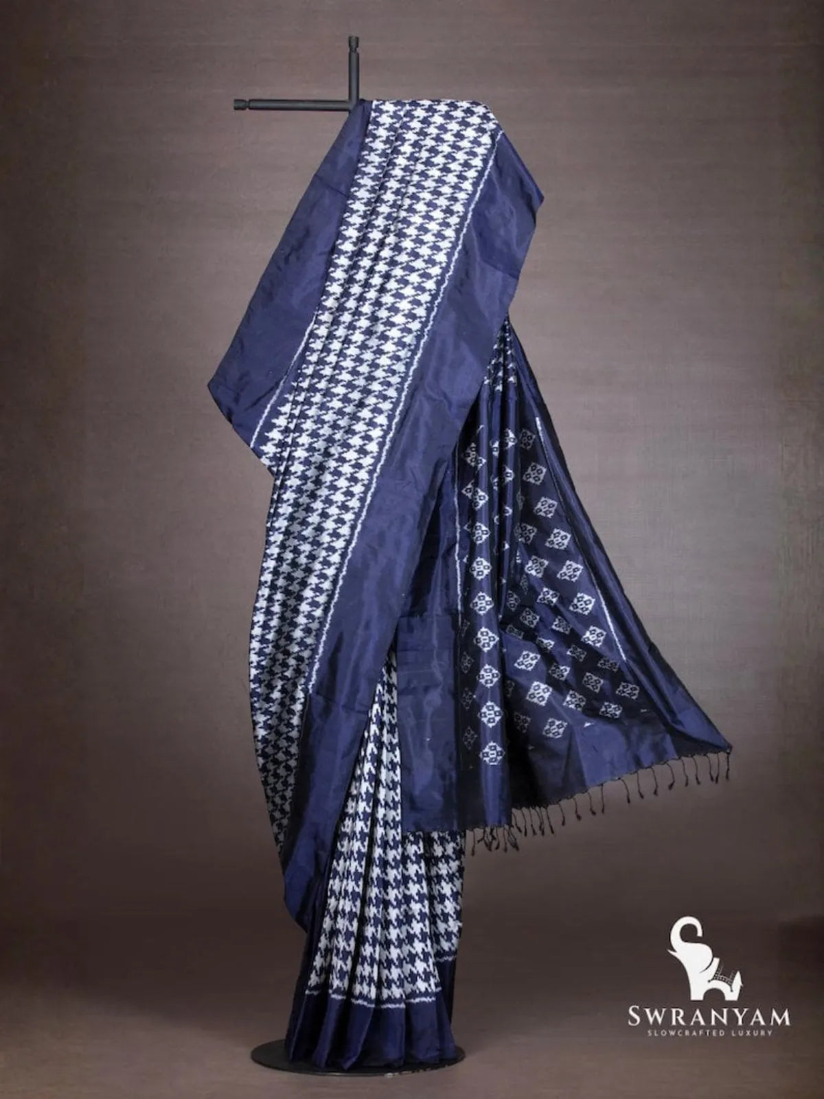 Indigo blue ikat silk saree with white houndstooth body and flowing pallu with diamond ikat motifs and black tassels