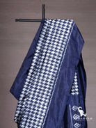 Close-up of white houndstooth ikat pattern on indigo blue silk saree shoulder drape with solid indigo border
