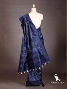 Back view of indigo blue Pochampally ikat silk saree showing pallu with white ikat bands and tassels