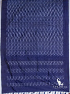 Indigo blue Pochampally ikat silk saree spread flat showing white chevron ikat body, solid border and pallu with tassels