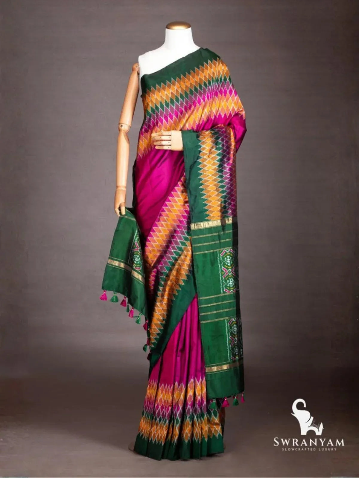 Wine purple Pochampally ikat silk saree with multicolour diamond ikat and emerald green border draped on mannequin