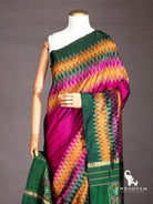 Close-up of wine purple ikat silk saree shoulder drape with mustard, pink and green diamond ikat pattern and zari border