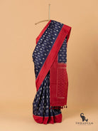 Navy blue Pochampally ikat silk saree with red border draped on stand, full front view with tasselled pallu