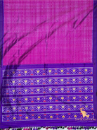 Flat lay of pink Pochampally ikat silk saree with zigzag body and purple pallu bands of traditional ikat motifs