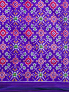 Purple ikat silk section with red, green and yellow traditional geometric motifs of pink Pochampally saree