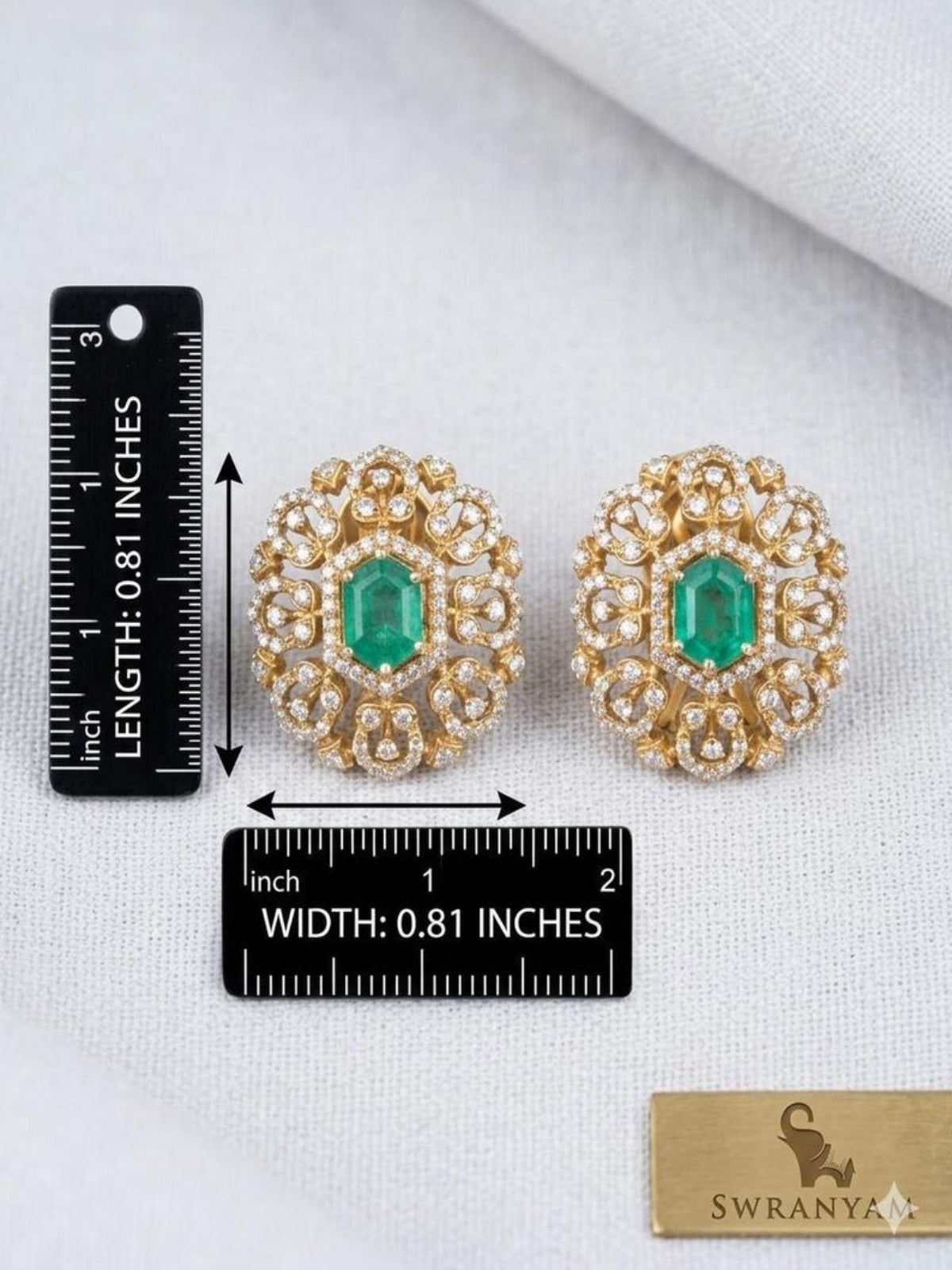 Swranyam silver stud earrings displayed on jewelry box with measurement ruler
